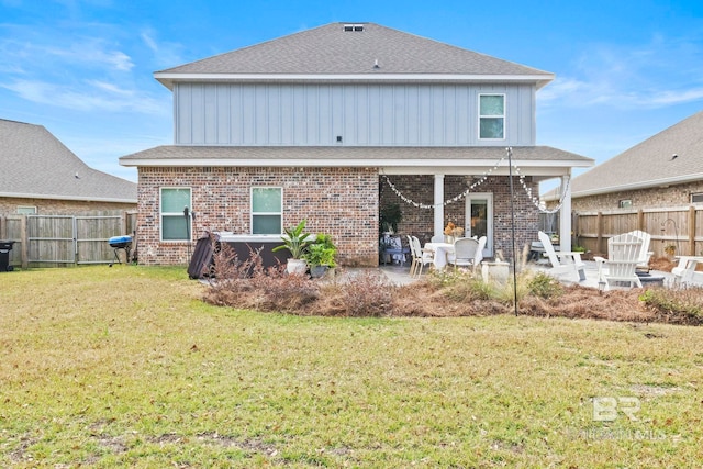 back of house featuring a yard and a patio