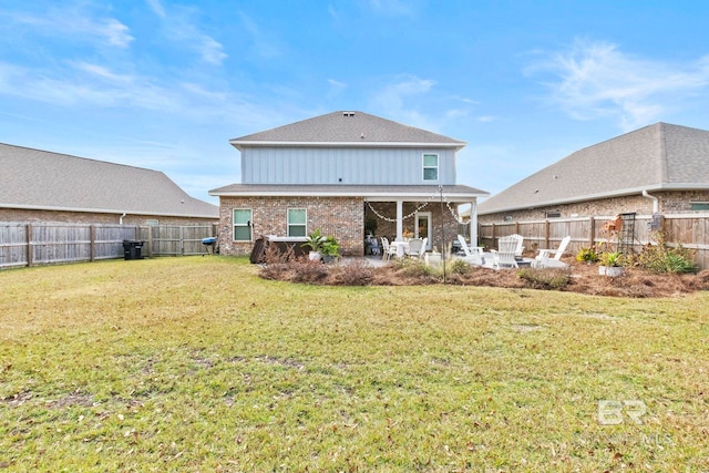 rear view of house with a yard and a patio area