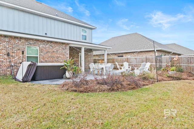 back of property with a patio and a lawn