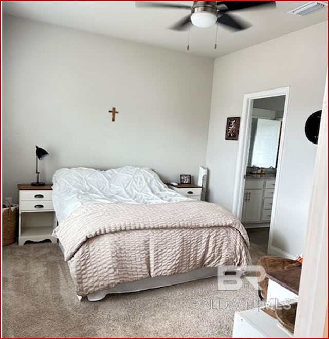 bedroom featuring ensuite bath, ceiling fan, and carpet floors