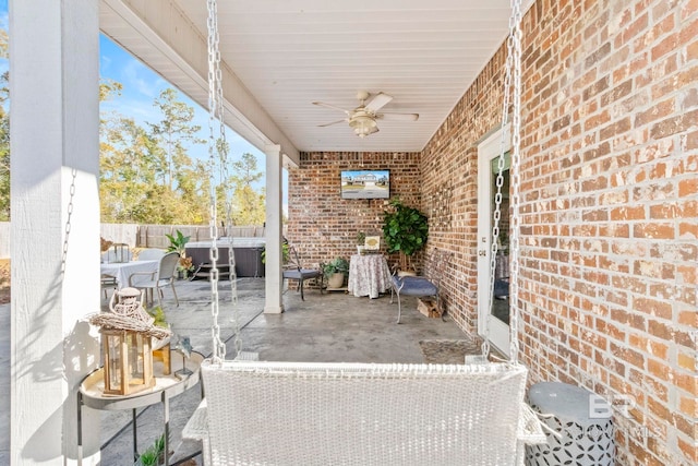 view of patio featuring ceiling fan and a hot tub