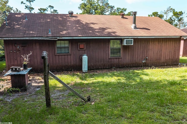rear view of property featuring a lawn