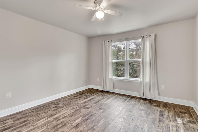 empty room with dark wood-type flooring and ceiling fan