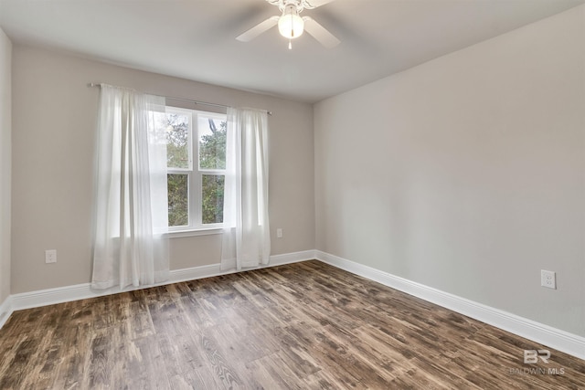 spare room with dark hardwood / wood-style floors and ceiling fan