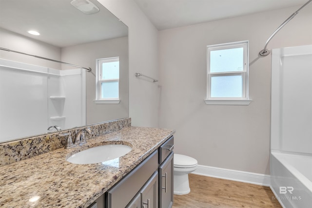 bathroom with hardwood / wood-style flooring, vanity, and toilet