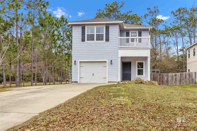 view of front property with a garage, a front yard, and a balcony
