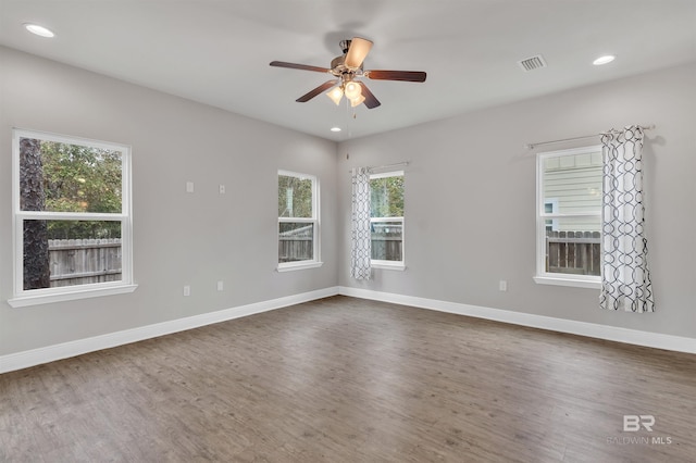 spare room featuring wood-type flooring and ceiling fan