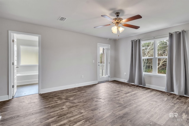 empty room featuring dark hardwood / wood-style flooring and ceiling fan