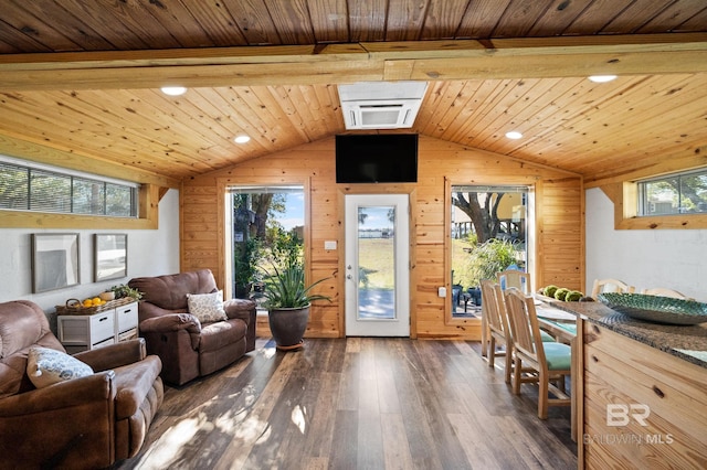 living room featuring dark wood-type flooring, wooden walls, vaulted ceiling with beams, a healthy amount of sunlight, and wood ceiling