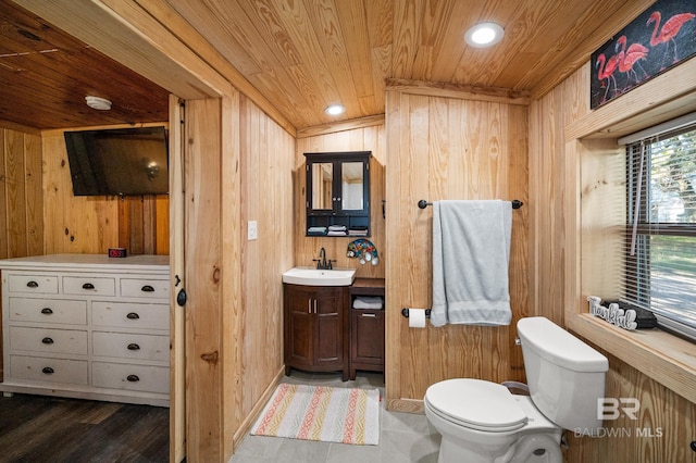 bathroom with wooden walls and wood ceiling