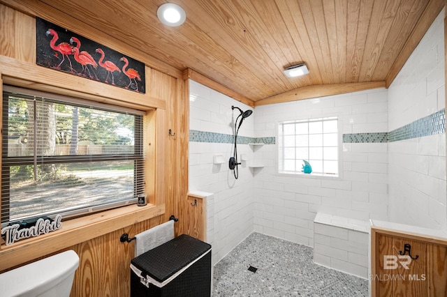 bathroom featuring a tile shower, vaulted ceiling, toilet, and wood ceiling