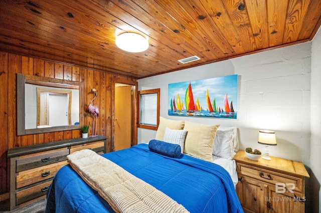 bedroom with wood walls, crown molding, and wooden ceiling