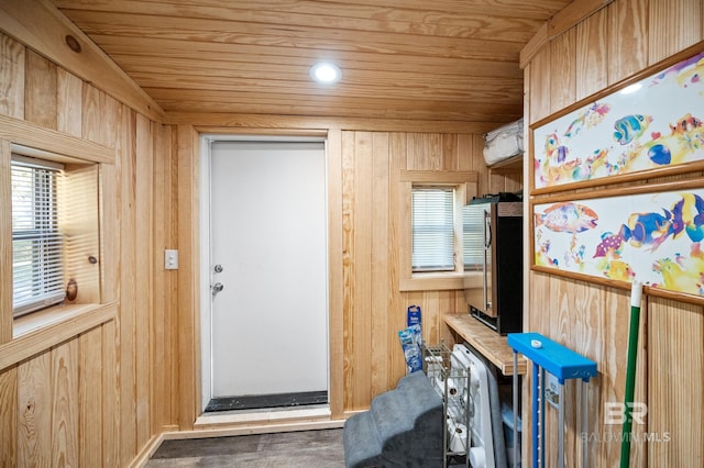 interior space with wood ceiling and wooden walls