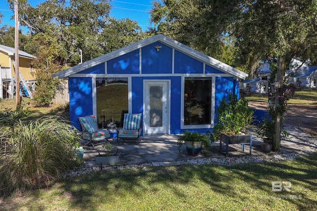 rear view of property featuring a yard