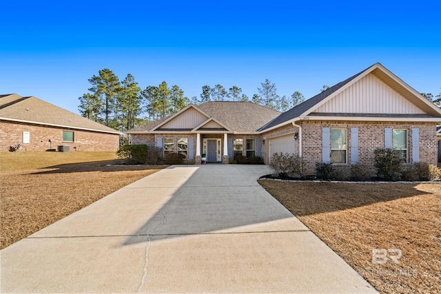 ranch-style house with cooling unit and a garage