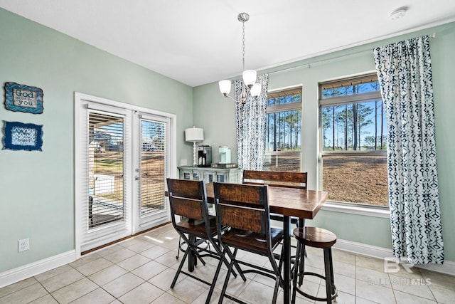 tiled dining room with an inviting chandelier and a healthy amount of sunlight