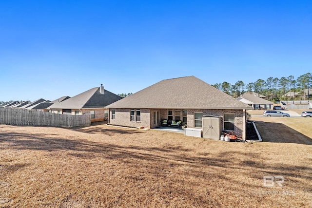 rear view of property with a lawn and a patio