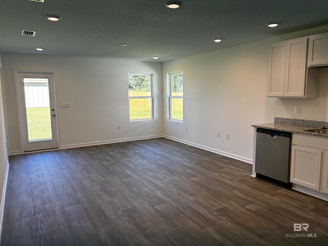 interior space with white cabinetry, stainless steel dishwasher, and dark hardwood / wood-style floors