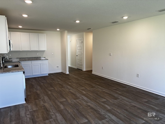 kitchen featuring sink, dark hardwood / wood-style floors, and white cabinets