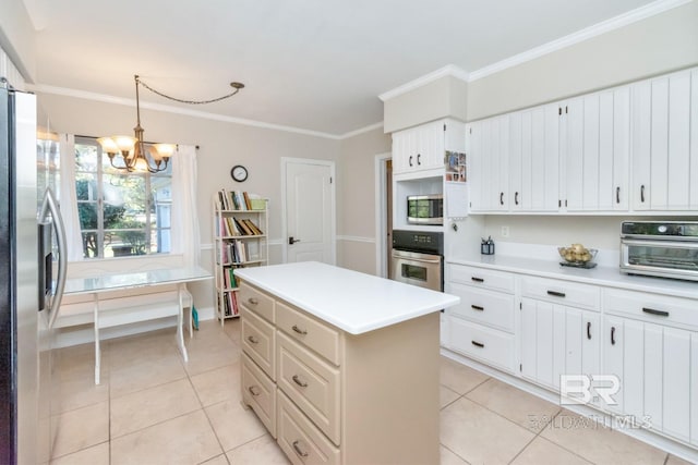 kitchen featuring a center island, stainless steel appliances, a notable chandelier, pendant lighting, and light tile patterned floors