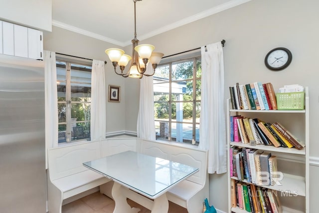 tiled dining area with ornamental molding and an inviting chandelier