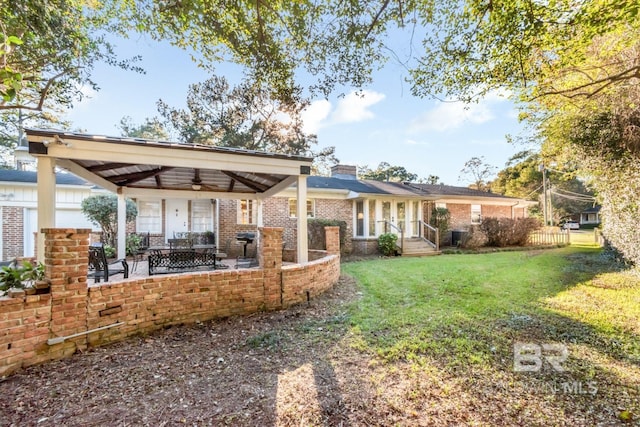 view of yard with a patio area and ceiling fan