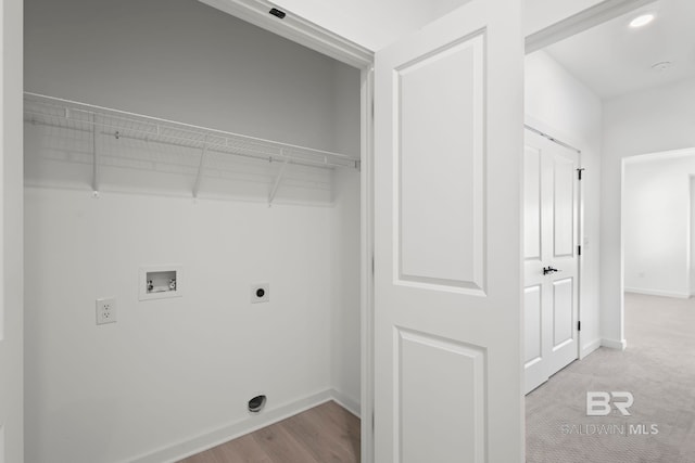 laundry room with hookup for an electric dryer, laundry area, washer hookup, wood finished floors, and baseboards