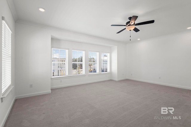 unfurnished room with ceiling fan, recessed lighting, light carpet, baseboards, and crown molding