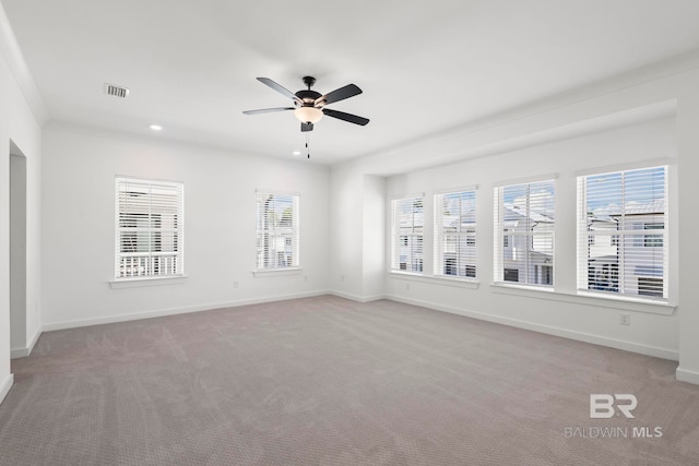 unfurnished room with light carpet, visible vents, and baseboards