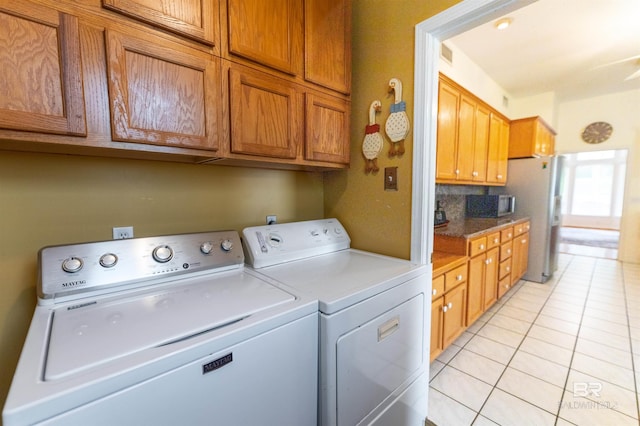 1619 Silver Creek Ct, Saraland, AL 36571 - laundry room with washer and dryer, light tile patterned floors, and cabinet space