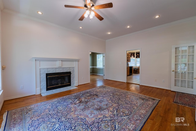 1619 Silver Creek Ct, Saraland, AL 36571 - unfurnished living room featuring crown molding, a ceiling fan, wood finished floors, a tile fireplace, and recessed lighting
