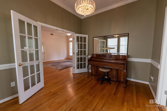 1619 Silver Creek Ct, Saraland, AL 36571 - sitting room featuring french doors, crown molding, healthy amount of natural light, a chandelier, and wood finished floors