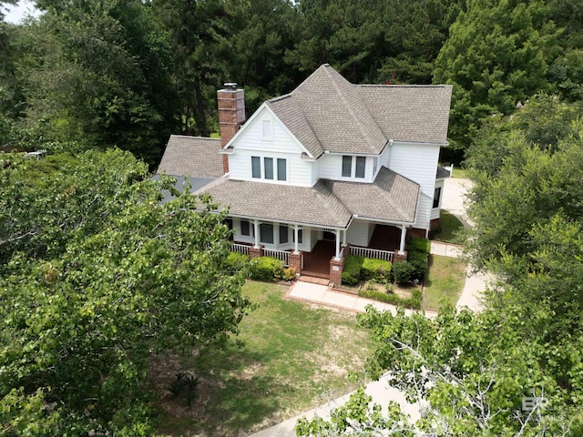 1619 Silver Creek Ct, Saraland, AL 36571 - view of front of home with a porch, a chimney, a wooded view, and roof with shingles