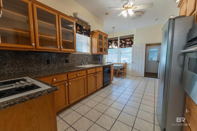1619 Silver Creek Ct, Saraland, AL 36571 - kitchen with freestanding refrigerator, black dishwasher, brown cabinetry, and decorative backsplash