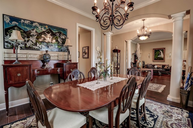 dining space with decorative columns, crown molding, dark hardwood / wood-style flooring, and a notable chandelier