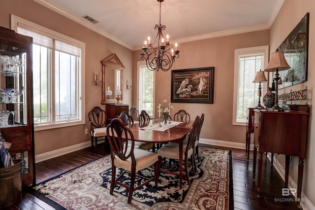 dining space featuring a chandelier, dark hardwood / wood-style floors, crown molding, and a healthy amount of sunlight