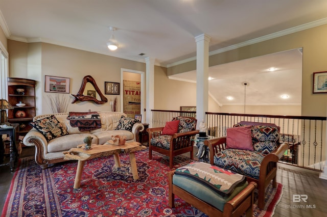 living room featuring hardwood / wood-style floors, lofted ceiling, ornamental molding, and decorative columns