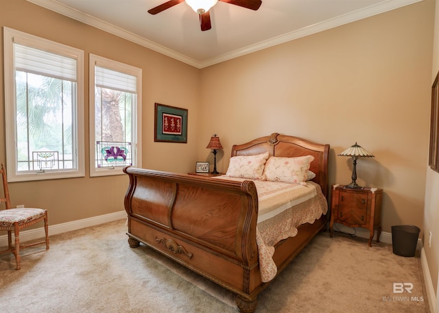 carpeted bedroom with ceiling fan and crown molding