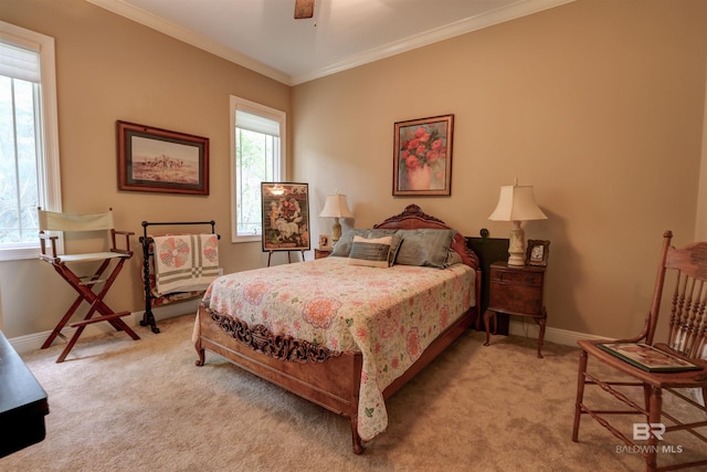 bedroom featuring light colored carpet, ceiling fan, and ornamental molding