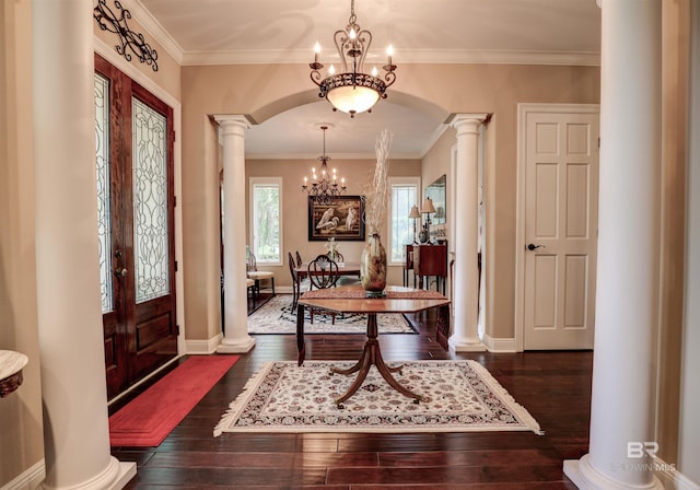 entrance foyer featuring a chandelier, french doors, dark hardwood / wood-style floors, and ornamental molding