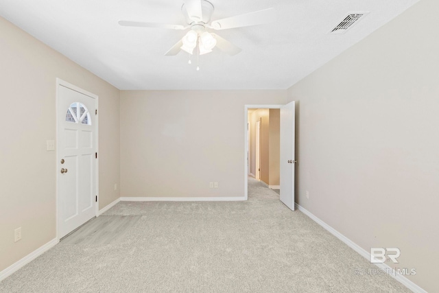 carpeted spare room with ceiling fan