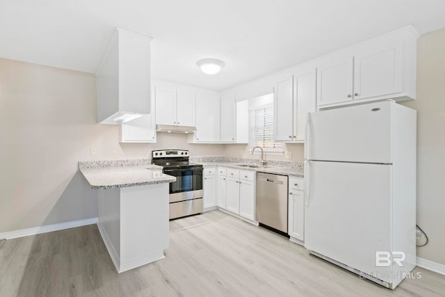 kitchen featuring stainless steel appliances, light stone counters, white cabinets, light hardwood / wood-style floors, and sink