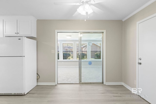 unfurnished dining area featuring light hardwood / wood-style flooring and ceiling fan