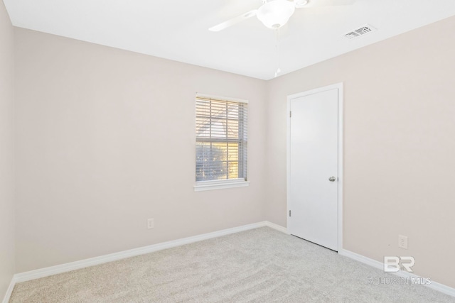 carpeted empty room featuring ceiling fan