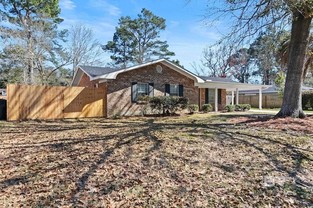 212 Lee St, Fairhope, AL 36532 - exterior space with brick siding, fence, and a carport