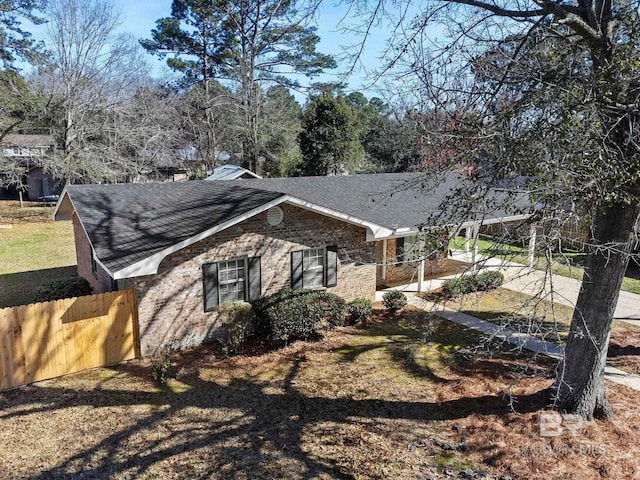 212 Lee St, Fairhope, AL 36532 - view of side of home with roof with shingles, fence, a chimney, and brick siding