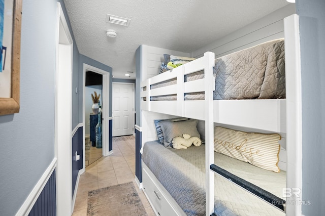 tiled bedroom with visible vents