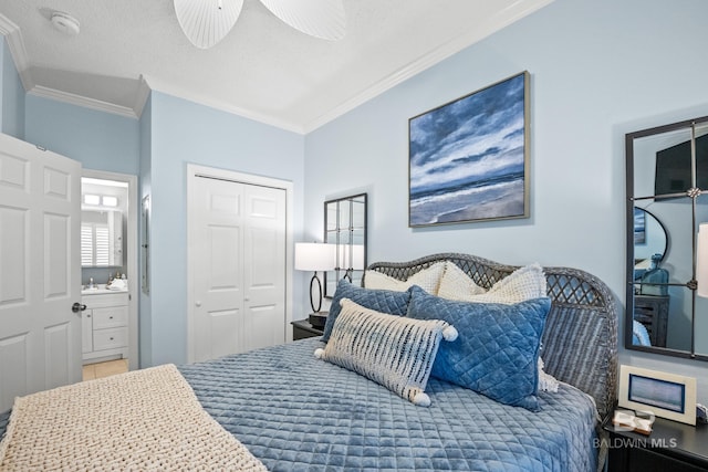 bedroom with ornamental molding, connected bathroom, and a closet