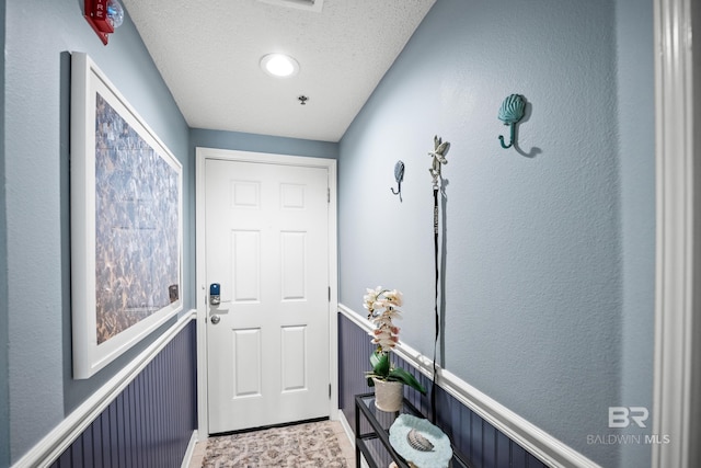 entryway with a textured ceiling