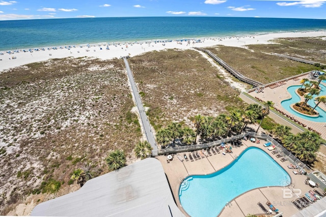 aerial view with a water view and a beach view